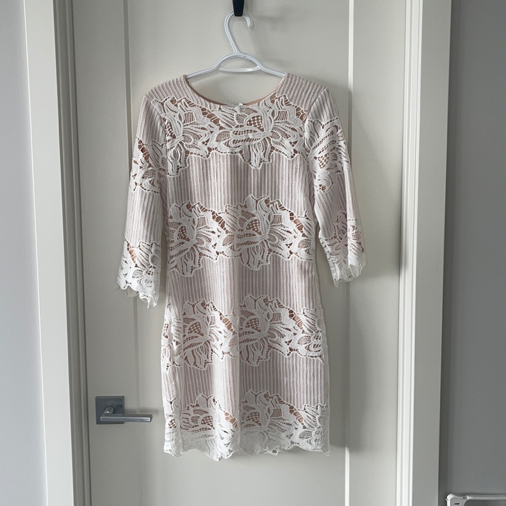 White dress with nude underlay.